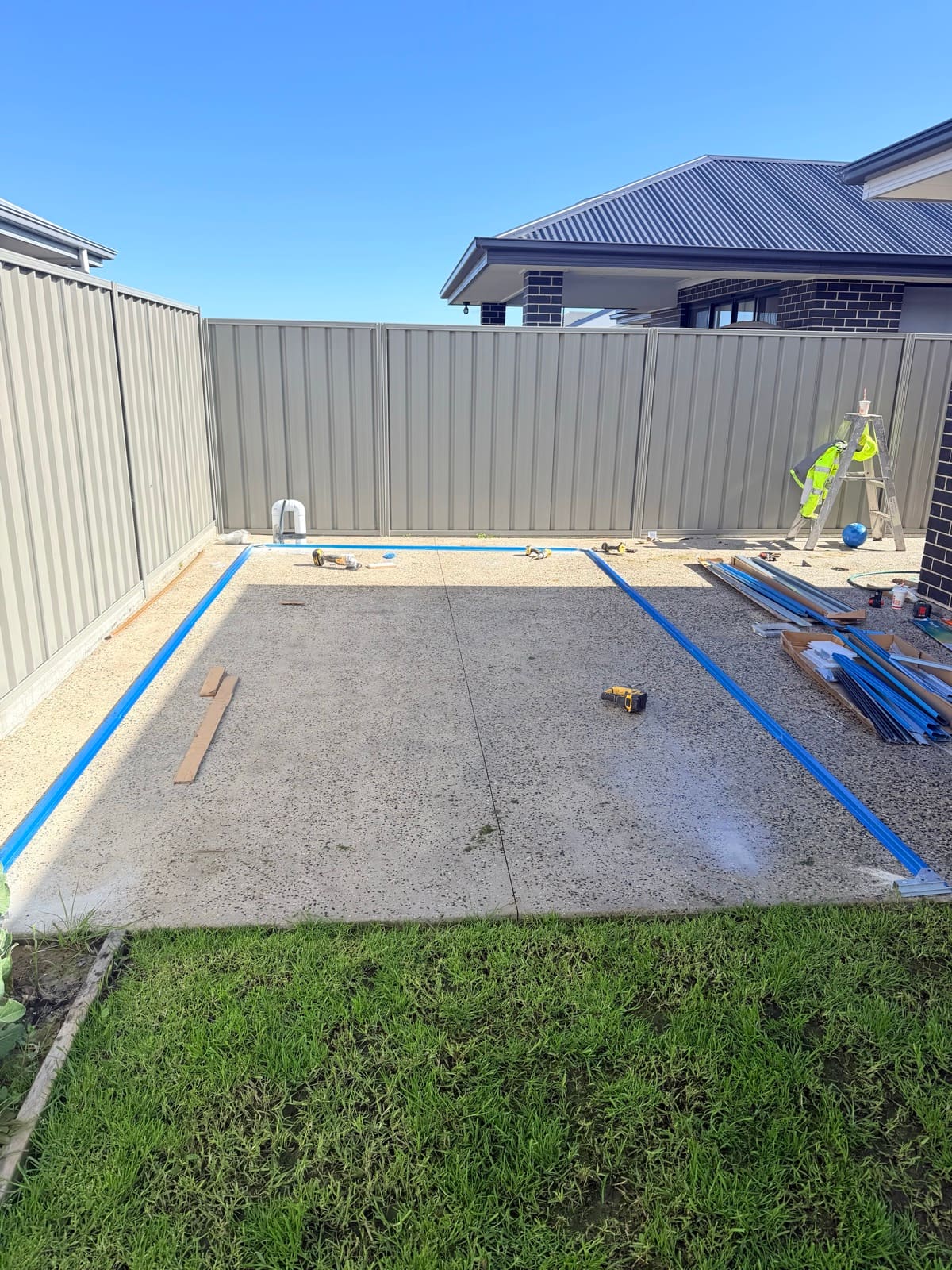 Garden shed base rails laid out on a concrete slab during installation in Adelaide