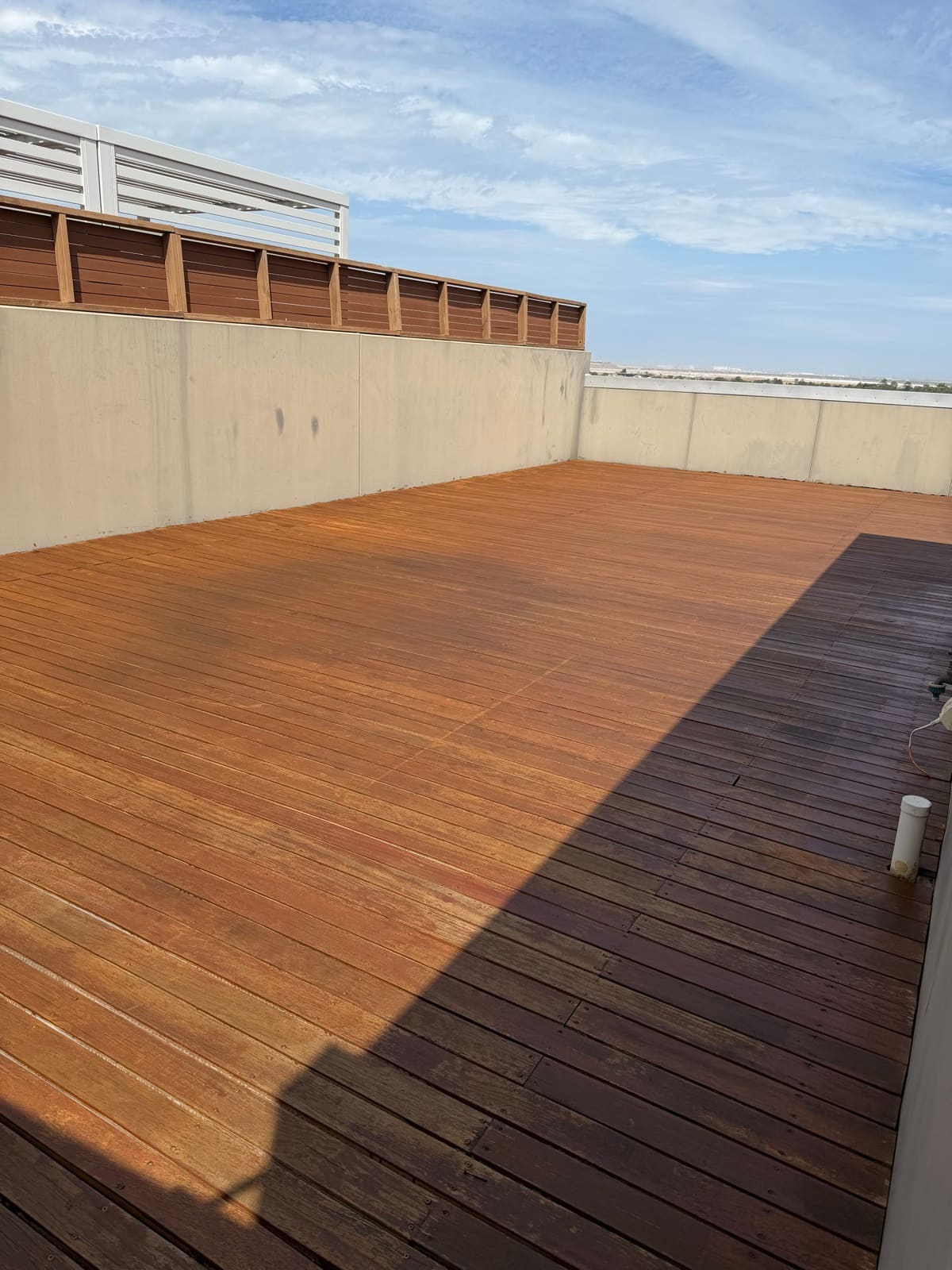 Outdoor timber decking planks on an Adelaide rooftop terrace ready for maintenance work